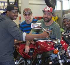 Students working on a motorcycle at the small engine labs